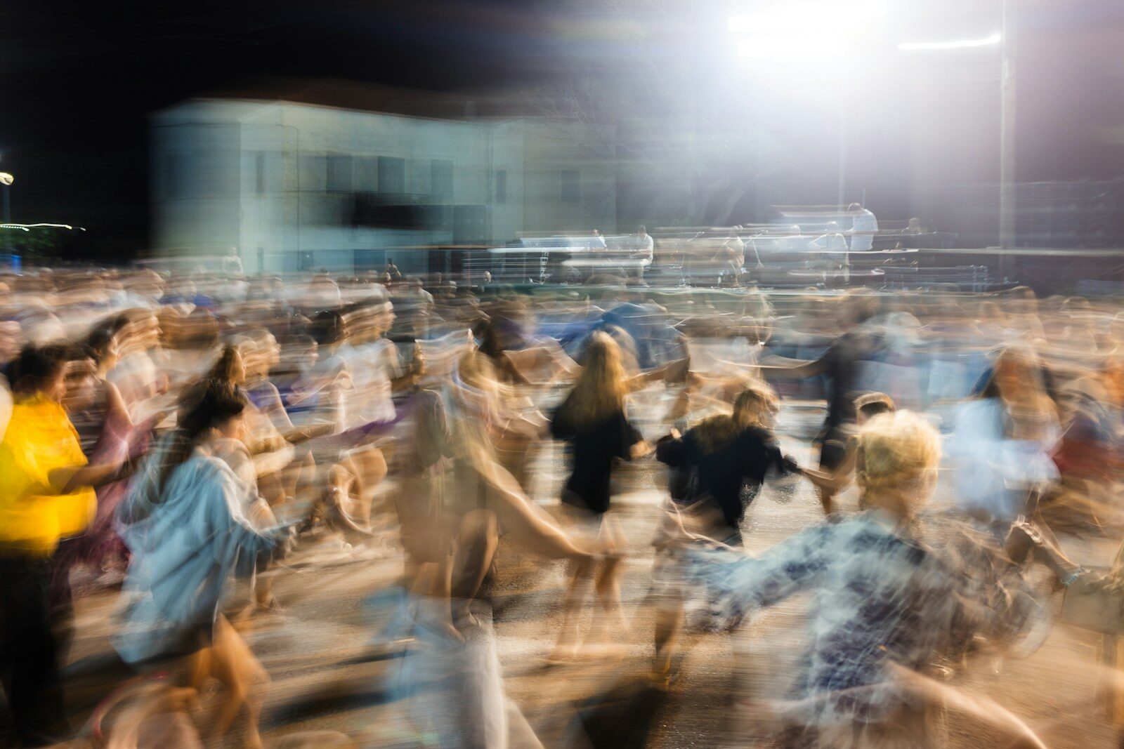 Blurred motion of people dancing at night